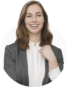 A professional looking woman in a blazer, smiling at the camera.